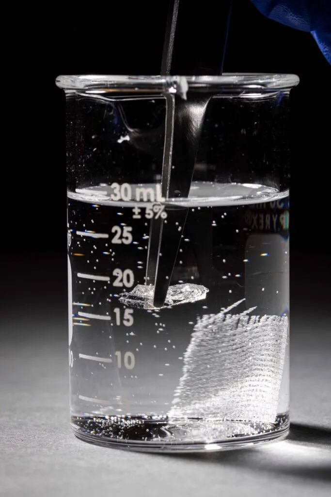 Vitreous polymer material removed with tweezers